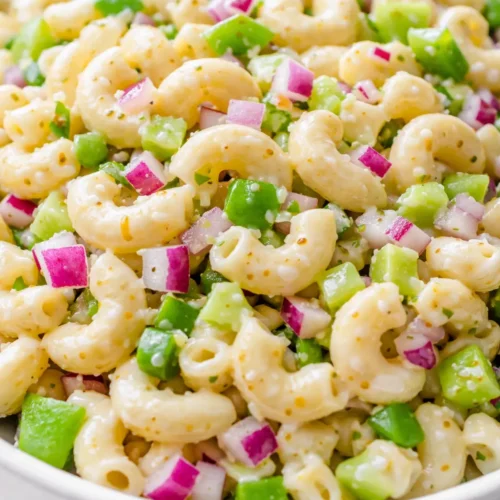 Creamy classic macaroni salad with tender pasta, crunchy vegetables, and a tangy dressing, never soggy.