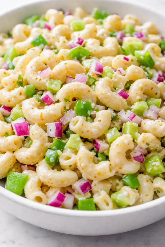 Creamy classic macaroni salad with tender pasta, crunchy vegetables, and a tangy dressing, never soggy.
