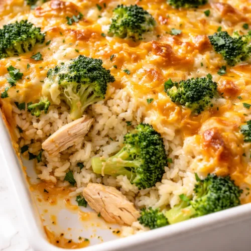 Creamy broccoli cheddar chicken and rice casserole baked until golden, with melted cheese and tender broccoli pieces.