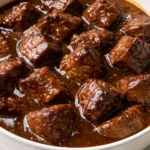 Tender carne guisada braised beef in rich gravy with warm flour tortillas, sprinkled with cilantro and diced tomatoes.