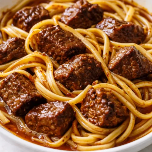 Rich, tender Mississippi beef noodles from a crock pot, with thick savory sauce coating wide egg noodles, never watery.
