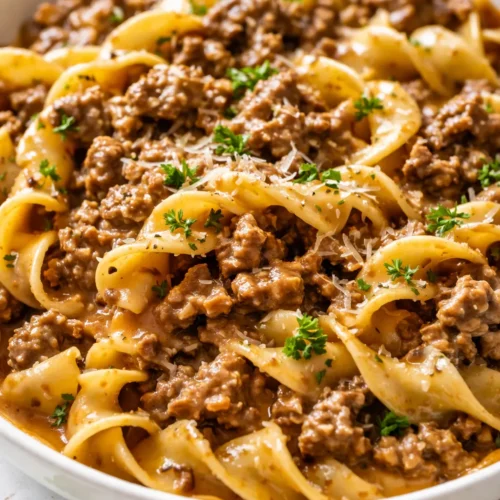 Rich and creamy ground beef stroganoff with tender ground beef in a velvety sauce, served over egg noodles.