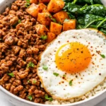 A hearty healthy turkey breakfast bowl loaded with scrambled eggs, diced turkey breast, creamy avocado, and juicy cherry tomatoes, topped with fresh cilantro for a colorful and nutritious start.