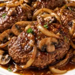 Simple Salisbury Steak patty topped with rich savory gravy and served with mashed potatoes.