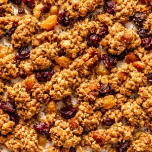 Golden almond flour granola clusters with dried fruit and cardamom, perfectly crunchy and clustered