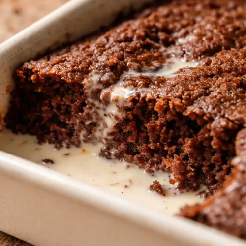 Ultimate chocolate tres leches cake slice with creamy soaked layers and glossy chocolate glaze