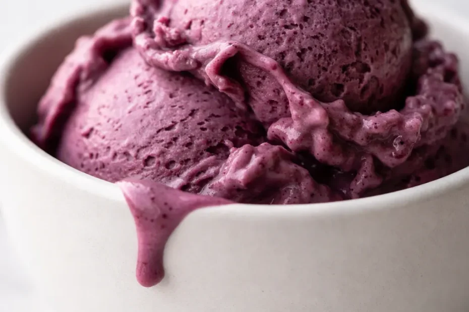 Creamiest Ninja Creami blueberry cheesecake protein ice cream in a pint, smooth creamy texture with berry swirl and graham crumble