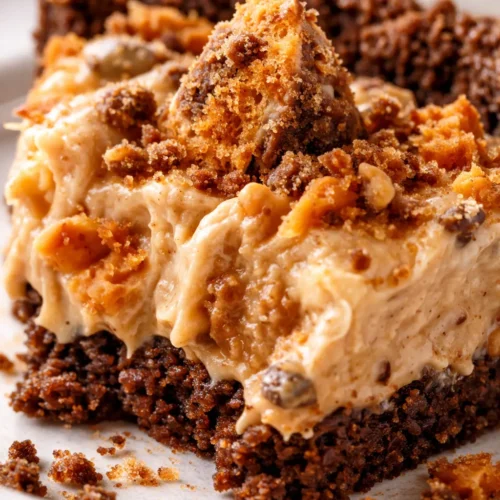 Creamy no-bake Butterfinger pie slice with crunchy graham cracker crust and chocolate crumbles on top