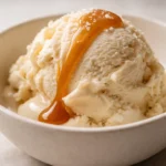 Creamy Ninja Creami salted caramel protein ice cream in a bowl, smooth texture with caramel swirls and flaky sea salt on top