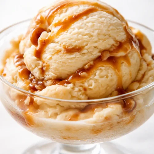 Creamy Bailey's Irish Cream ice cream scoop with smooth, velvety texture and a pale golden color, ready to serve.