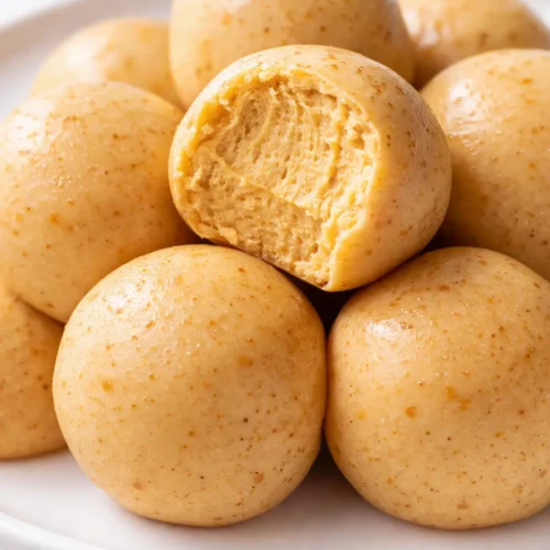 No-Bake Pumpkin Cheesecake Truffles with a creamy, spiced center and golden crumble coating.
