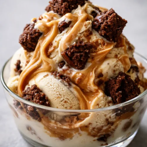Creamy peanut butter brownie ice cream with fudgy brownie chunks and a peanut butter swirl, served in a chilled bowl