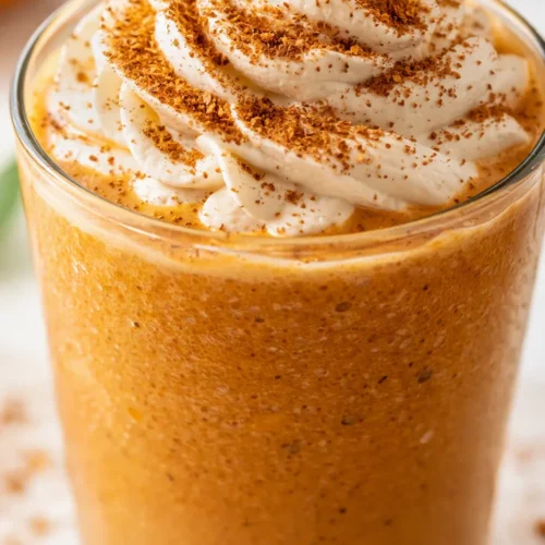 Frosted copycat Starbucks Pumpkin Spice Frappuccino with creamy whipped cream, caramel drizzle, and a spiced orange-brown swirl.